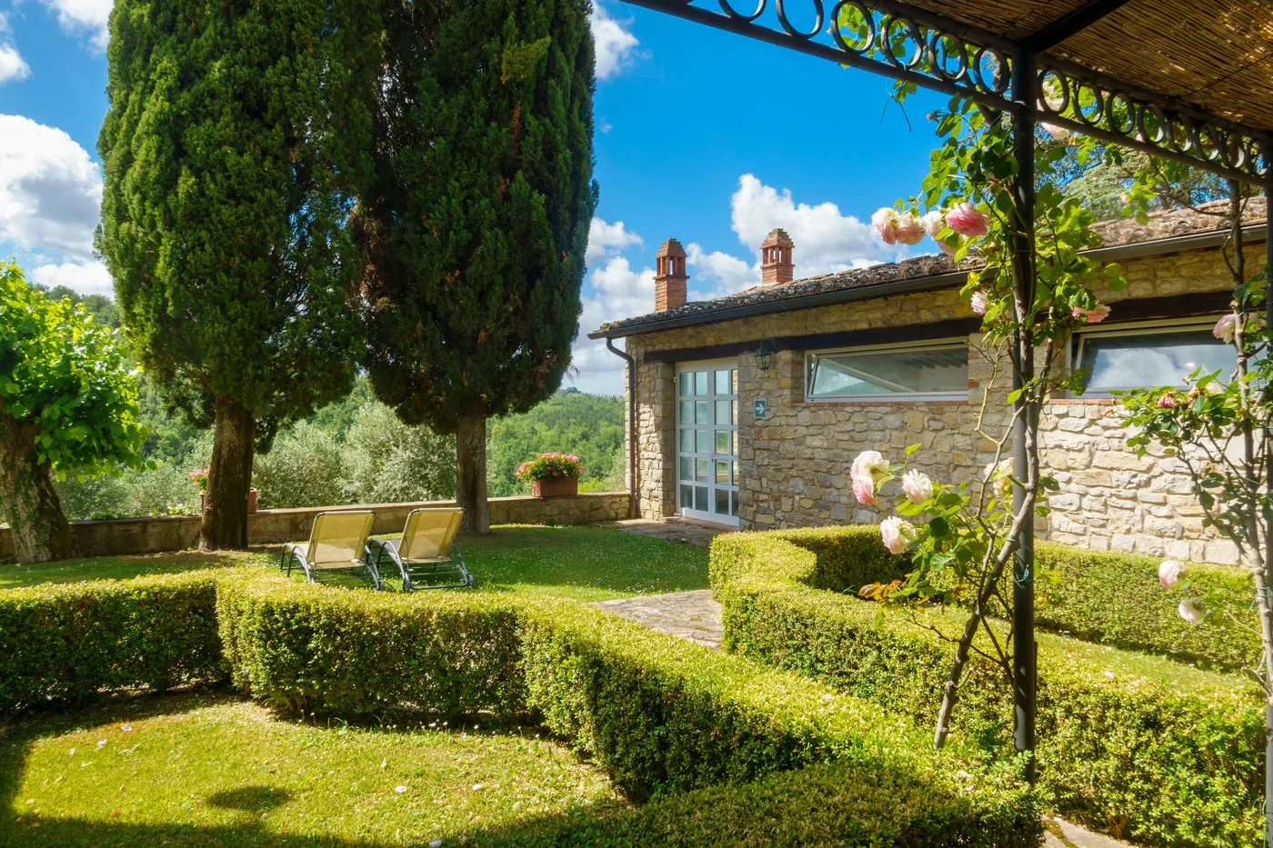 A stone villa surrounded by mature planting